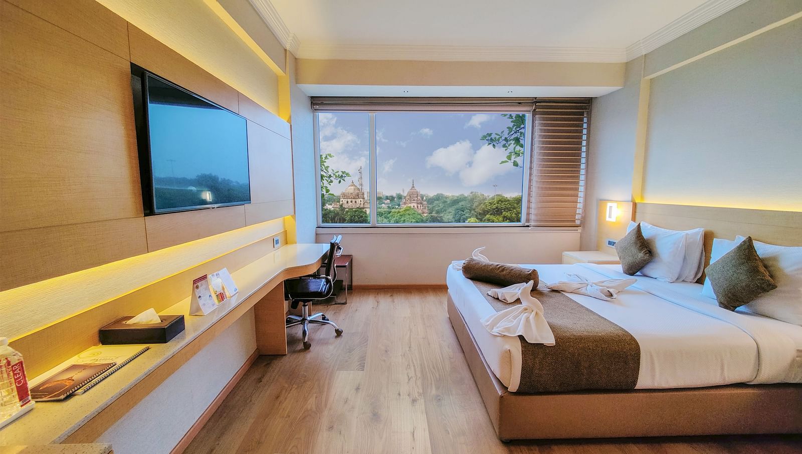 An overview of the Suite at Gemini Continental with a king bed and a tv opposite it.